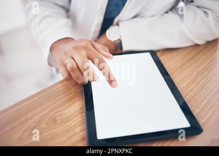 Mockup, typing and hand of doctor on a tablet for healthcare, email and online services. Research, medical and a pharmacist or medic worker scrolling Stock Photo