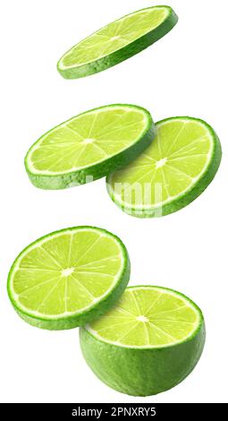 Isolated flying limes. Falling sliced lime fruit isolated on white background with clipping path Stock Photo