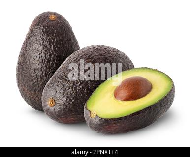 Isolated avocados. Two whole black avocado fruits with a half isolated on white background with clipping path Stock Photo