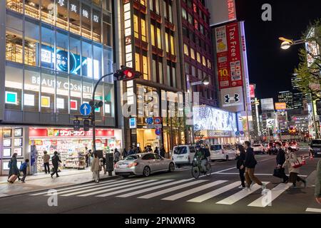 April 2023 Shinjuku Tokyo evening time and crowds and neon lights keep the city alive, zebra and pelican crossings street scene Japan,Asia Stock Photo