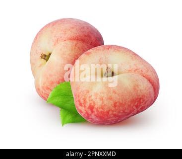 Isolated peaches. Two flat peach fruit with leaves isolated on white background Stock Photo