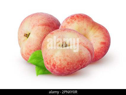 Isolated peaches. Three flat (donut) peach fruit with leaves isolated on white background Stock Photo