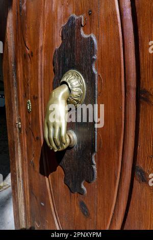 Old knocking door knob on wooden door, closeup Stock Photo