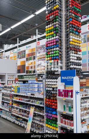 Large selection of paints from different manufacturers on shelves in store. Minsk, Belarus, 2025 Stock Photo