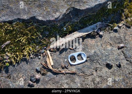 separate tab of a beer can on ground outdoors Stock Photo