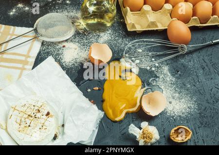 A broken egg on the table, a mess at the cook's workplace. Chicken egg dropped on the table. Place for text Stock Photo