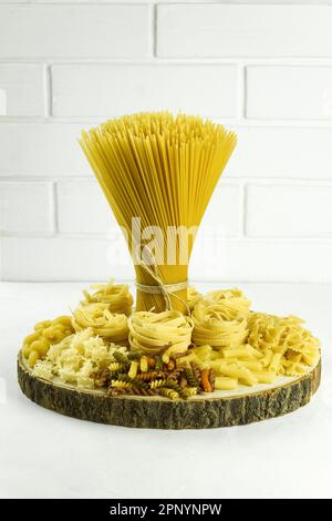 Spaghetti dry, A bunch of spaghetti tied with a rope. Pasta, high quality photo. Vertical photo. copy space Stock Photo