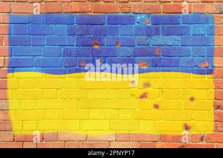 The flag of Ukraine is painted on a brick wall. Flag on an old stone wall. Large national Ukrainian flag on a massive old brick wall Stock Photo
