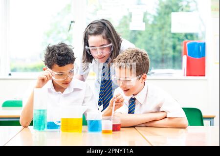 Three three young scientists in a science lab checking formulas and preparation for their work, at school Stock Photo