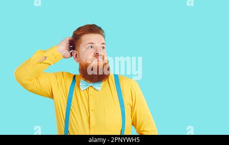 Fat man scratching his head and looking at copy space with funny confused expression Stock Photo