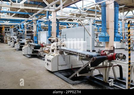 Beautiful metal industrial equipment of a production line at a machine-building plant, a conveyor with machine tools for products. Equipment refinery, Stock Photo