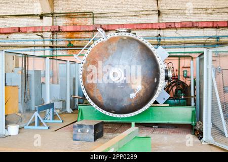 Large metal iron distillation column for separation of substances into fractions in the industrial premises of the shop at an oil refinery, chemical, Stock Photo