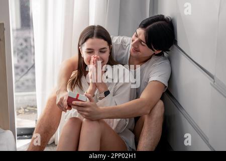 Lovers sharing gifts on special and memorable anniversaries. A couple spending quality time to celebrate together. A romantic and lovely moment create Stock Photo