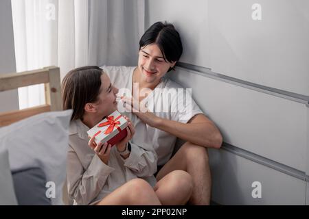 Lovers sharing gifts on special and memorable anniversaries. A couple spending quality time to celebrate together. A romantic and lovely moment create Stock Photo