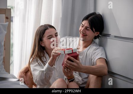 Lovers sharing gifts on special and memorable anniversaries. A couple spending quality time to celebrate together. A romantic and lovely moment create Stock Photo