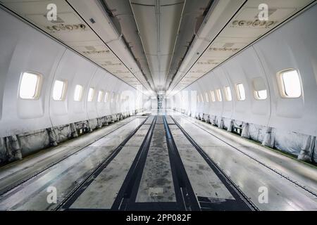 Commercial airplane under heavy maintenance. Inside of passenger cabit without seats and interior. Stock Photo