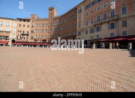 Piazza del Campo is the shell-shaped square where the Palio di Siena takes place. The Palazzo Pubblico and the Torre del Mangia dominate the square. Stock Photo