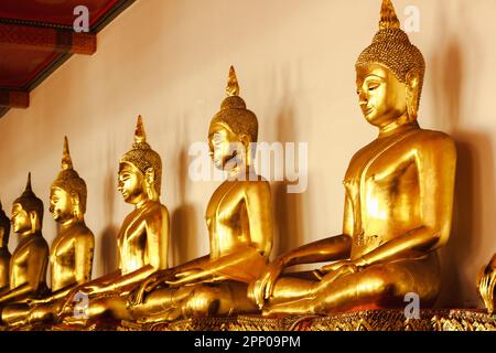 Beautiful golden Buddha On the pedestal, some white walls Stock Photo