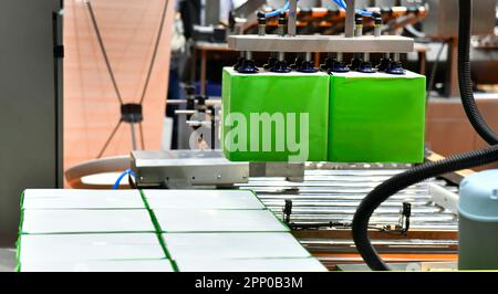 Industrial robotic arms carriage the cardboard box for delivery in warehouse. Stock Photo