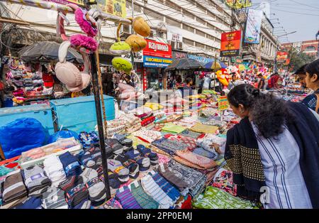 A roadside stall selling clothes and fabrics in the street in the New Market Area of Taltala, Kolkata (Calcutta), capital city of West Bengal, India Stock Photo