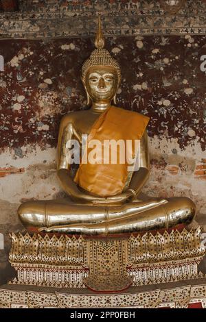 Golden Buddha beside old walls in Thai temples Stock Photo