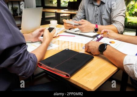 Business team meeting and discussing project plan. Businessmen using smartphone in meeting room. Professional investor working with business project t Stock Photo