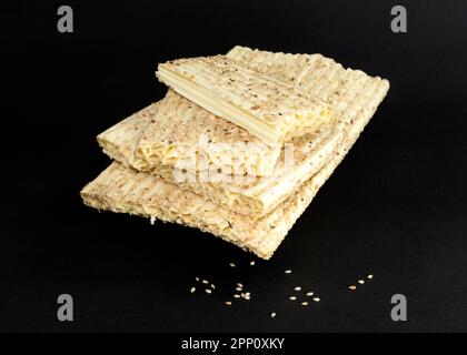 Sesame seed honey bar isolated on black background. Sesame seed kozinaki. Sesamum indicum L. Stock Photo