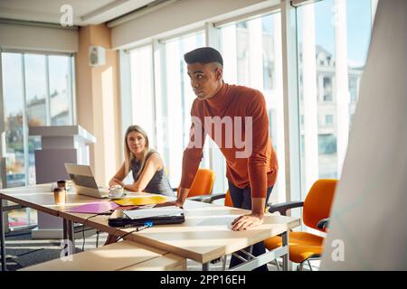 Young male lecturer giving a business lecture in a pleasant atmosphere in the conference room. Business, people, company Stock Photo