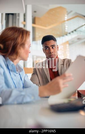 Two business colleagues in a working atmosphere at the office talking about job. Business, people, office, company Stock Photo