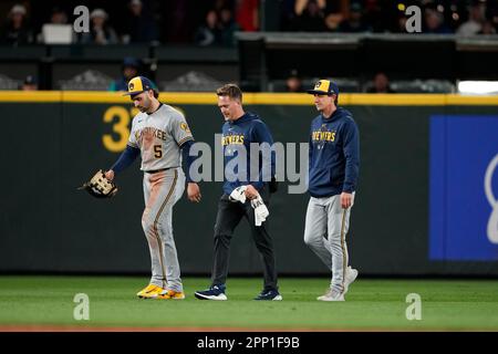 Milwaukee Brewers center fielder Garrett Mitchell leaves the game with a  shoulder injury, accompanied by head athletic trainer Scott Barringer,  center, and manager Craig Counsell, right, during a baseball game against  the
