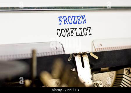 Frozen conflict symbol. Concept words Frozen conflict typed on beautiful old retro typewriter. Beautiful white background. Business and Frozen conflic Stock Photo