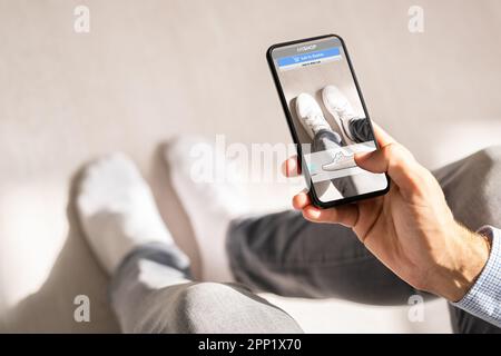 Man Trying Virtual Sneakers In Shop Or Store AR App Stock Photo
