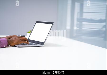 Close-up Of A Man Working On Laptop At Workplace Stock Photo