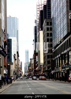the Yonge street in downtown Toronto. popular tourist and shopping area and destination. stores and tall office towers. car traffic. streetscape. Stock Photo