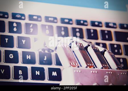 Robotic hand typing on a keyboard . Concept of future and AI. Stock Photo