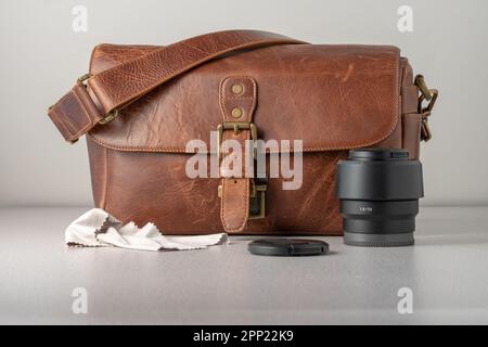 Brown leather camera bag. 50mm lens in the front. Head on shot. Stock Photo