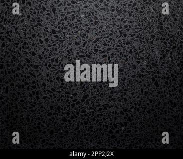 Gray terrazzo stone flooring with dark grey flecks, viewed from above. Abstract full frame textured background, top view. Stock Photo