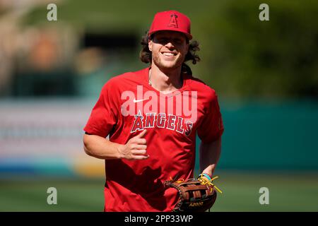 Los Angeles Angels' Brett Phillips fields a base hit by Texas Rangers'  Bubba Thompson during the xx inning of a spring training baseball game,  Saturday, March 18, 2023, in Tempe, Ariz. (AP