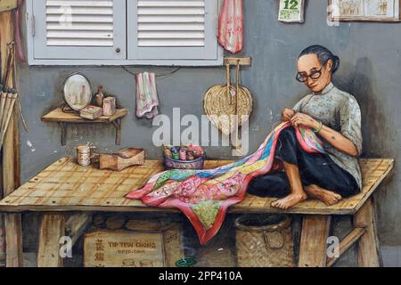 Detail of a mural by Singaporean artist Yip Yew Chong in Chinatown, Singapore, depicting a Chinese woman of old mending a blanket Stock Photo