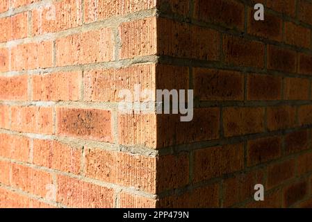The corner of a red brick wall Stock Photo