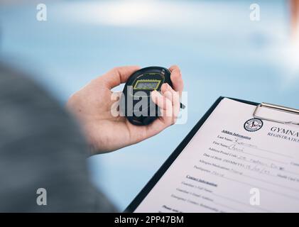 Hand, stopwatch and membership with a personal trainer in a gym, holding a sign up sheet during training. Fitness, sports and time with a coach using Stock Photo