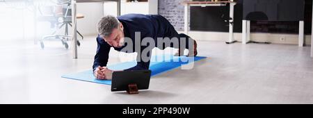 Man Doing Office Plank Exercise Workout Training Stock Photo