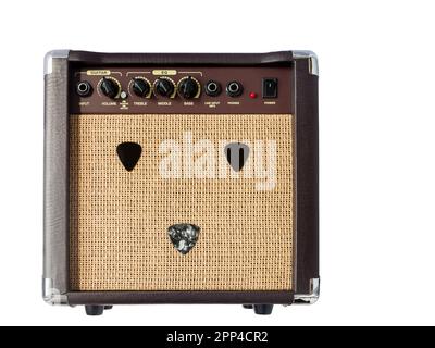 Small acoustic guitar amplifier with pick guitar on amplifier mask, isolated on white background Stock Photo