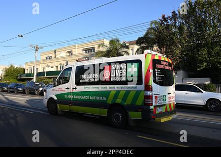 A St John Ambulance Australia complex patient transport vehicle, a Mercedes Benz Sprinter, traveling through the suburbs of Melbourne Stock Photo