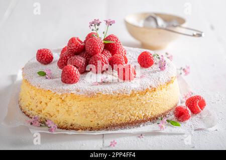 Tasty cheesecake decorated with raspberries and mint. Raspberry cheesecake. Stock Photo