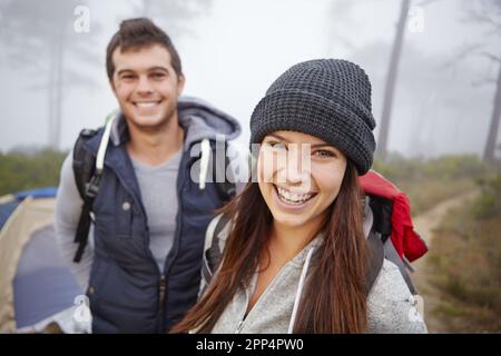 Enjoying the outdoors together. Portrait of a young couple on a hiking trip. Stock Photo