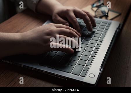 Woman typing on laptop. Close up photo. Chatting and meeting concept. Blogger. Journalist writing. Working from home. Internet and social networks. Stock Photo