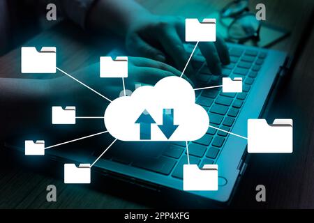 Woman using laptop with VR Cloud computing diagram interface. Data storage online. Networking and internet service concept. Backup Storage Data. Stock Photo