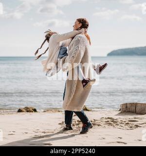 Full shot mother holding little girl Stock Photo