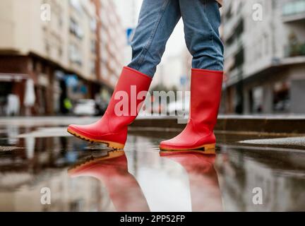 Red rain boots street Stock Photo